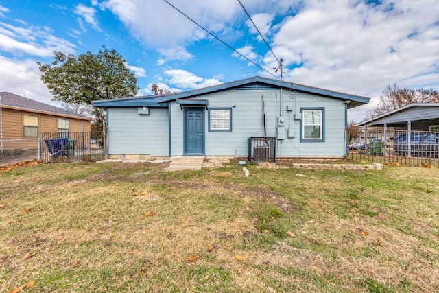 rear view of property with a lawn