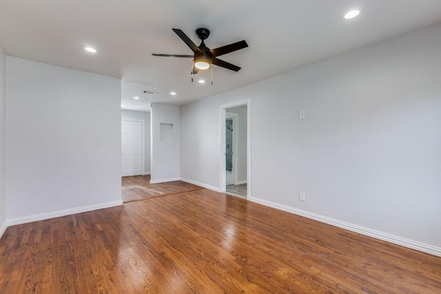 spare room with hardwood / wood-style flooring and ceiling fan