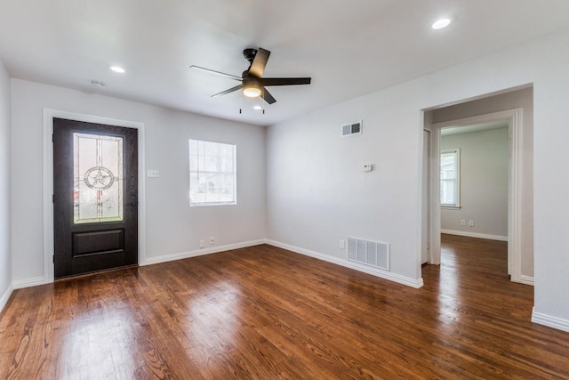 foyer entrance featuring plenty of natural light, ceiling fan, and dark wood-type flooring