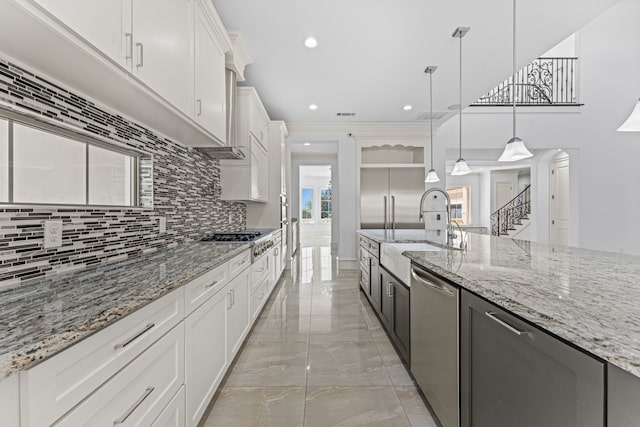 kitchen with white cabinets, pendant lighting, appliances with stainless steel finishes, and sink