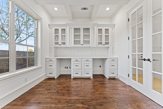 unfurnished office with beam ceiling, crown molding, french doors, and dark hardwood / wood-style floors