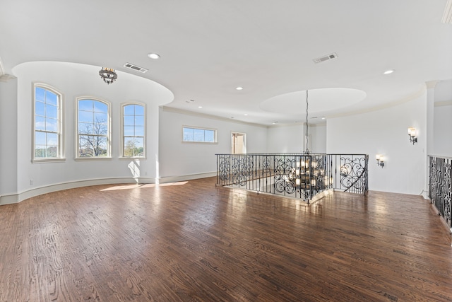 spare room featuring dark hardwood / wood-style flooring and crown molding