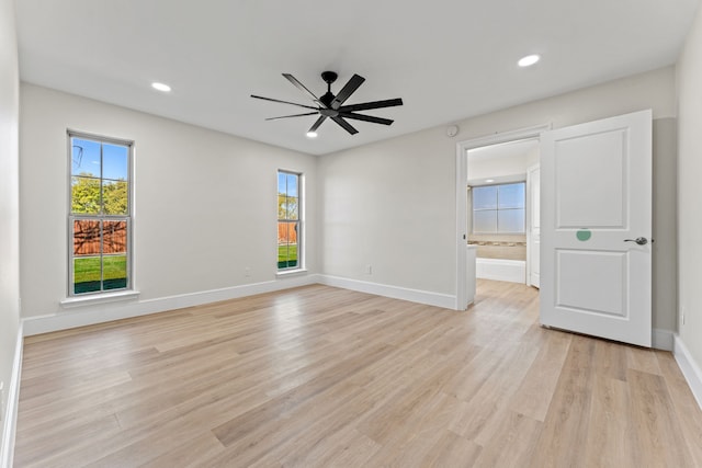 spare room featuring ceiling fan and light hardwood / wood-style flooring