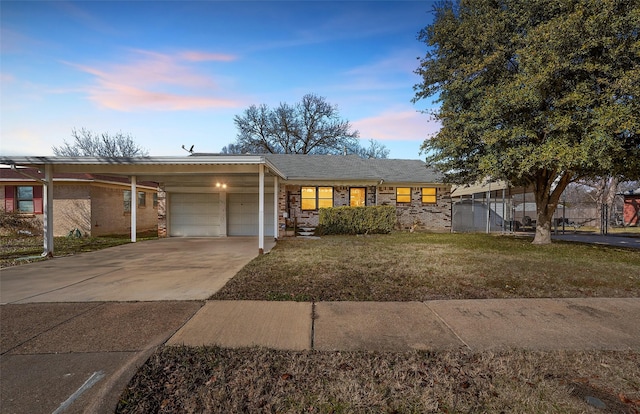 view of front of home featuring a garage, a carport, and a lawn