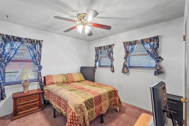 bedroom with ceiling fan and light carpet