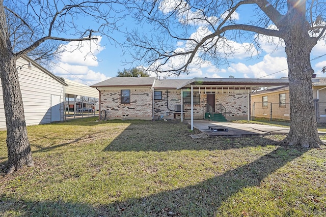 back of property with a patio area and a yard