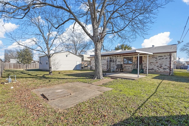 rear view of house featuring a lawn, a patio area, and an outdoor structure