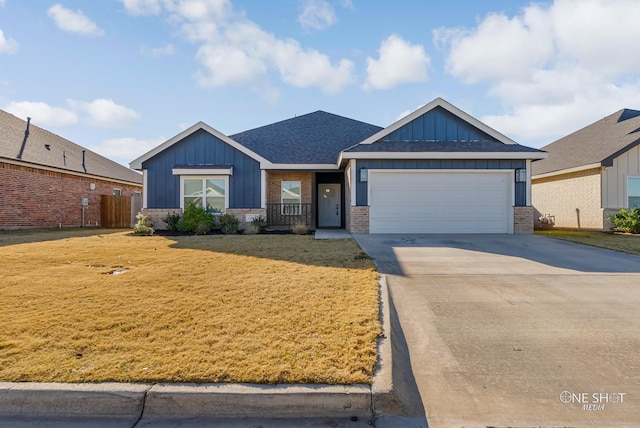 view of front of house with a garage and a front lawn