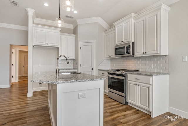 kitchen with light stone countertops, sink, white cabinets, and stainless steel appliances