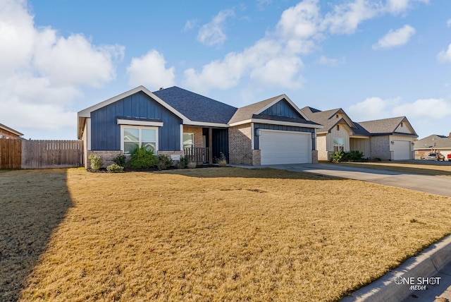 view of front of property with a garage and a front lawn