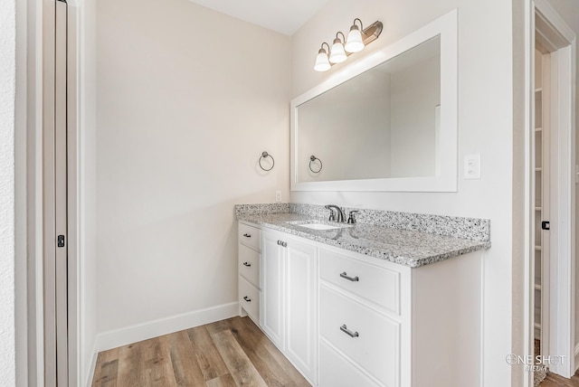 bathroom featuring hardwood / wood-style floors and vanity