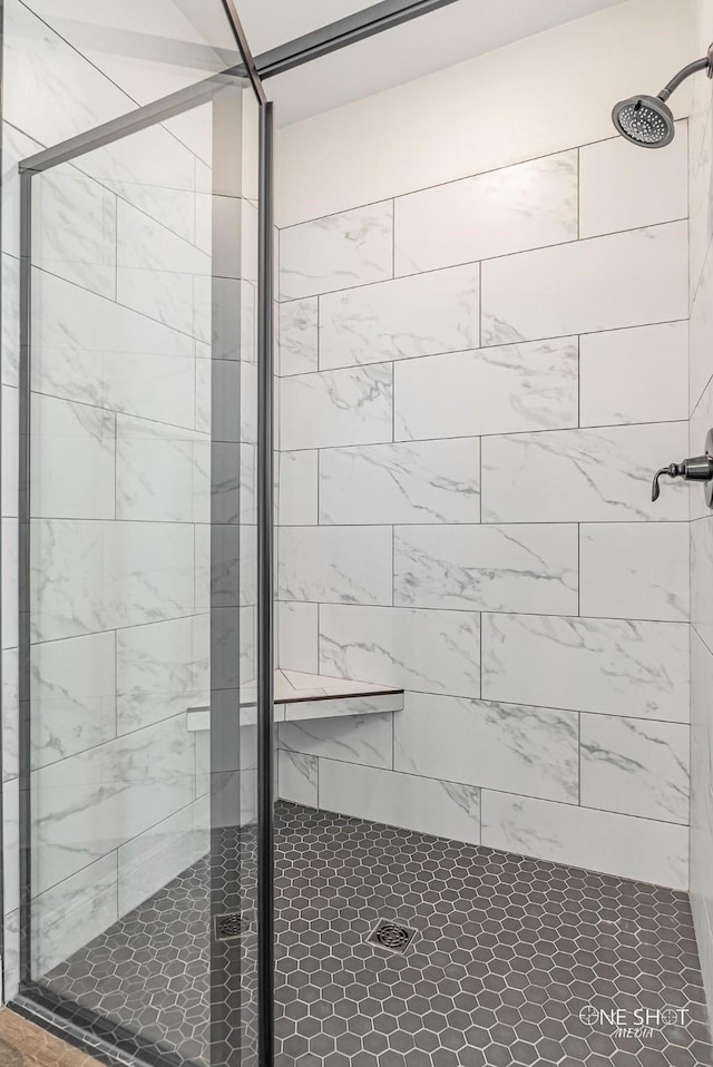 bathroom with a shower with shower door