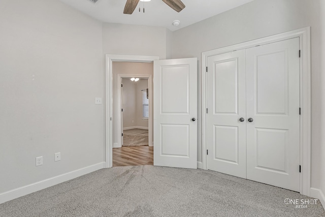 unfurnished bedroom with ceiling fan, a closet, and light carpet