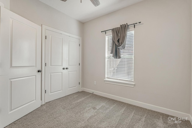 unfurnished bedroom featuring carpet flooring, a closet, and ceiling fan