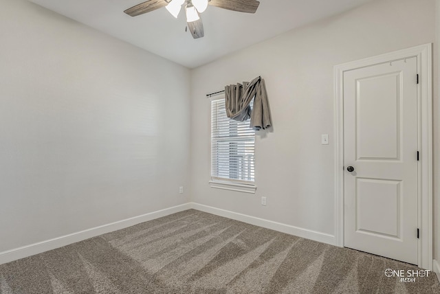 carpeted spare room featuring ceiling fan