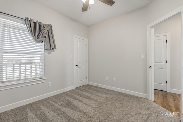 carpeted spare room with ceiling fan