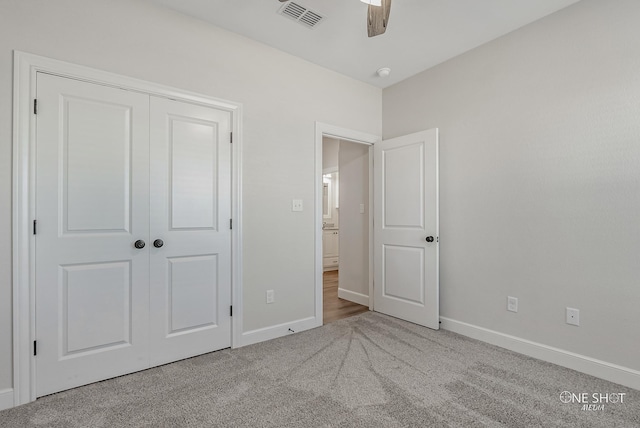 unfurnished bedroom with ceiling fan, a closet, and carpet