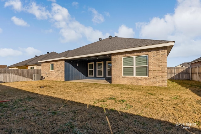 back of property featuring cooling unit, a lawn, and a patio area