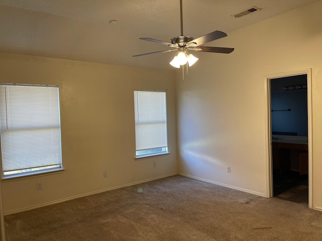 carpeted empty room featuring ceiling fan