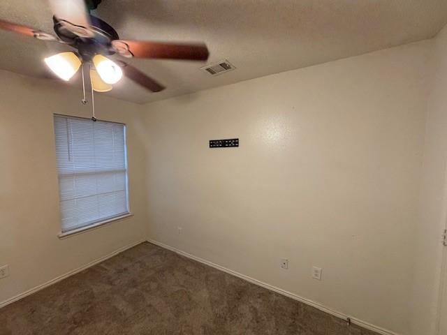 carpeted spare room with ceiling fan and a textured ceiling