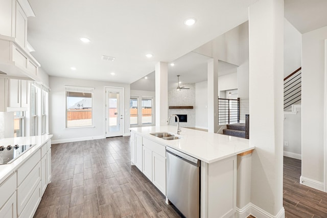 kitchen with black electric cooktop, sink, white cabinetry, and dishwasher