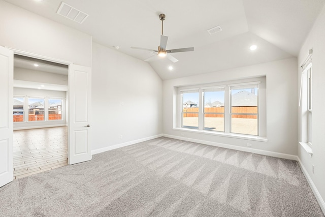 carpeted empty room with ceiling fan and vaulted ceiling