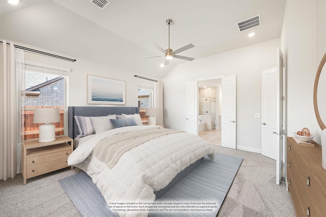 carpeted bedroom featuring lofted ceiling, ensuite bath, and ceiling fan