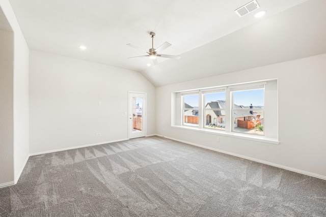 carpeted spare room featuring ceiling fan and lofted ceiling