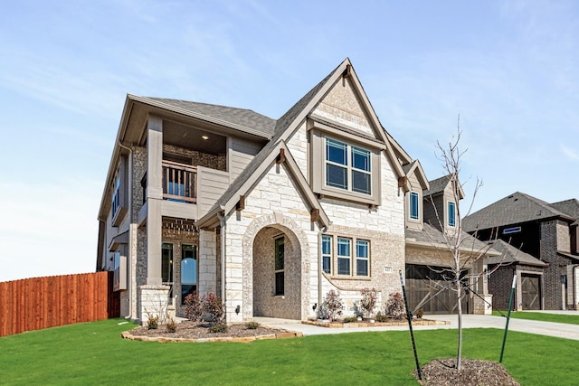 view of front of home with a balcony and a front lawn