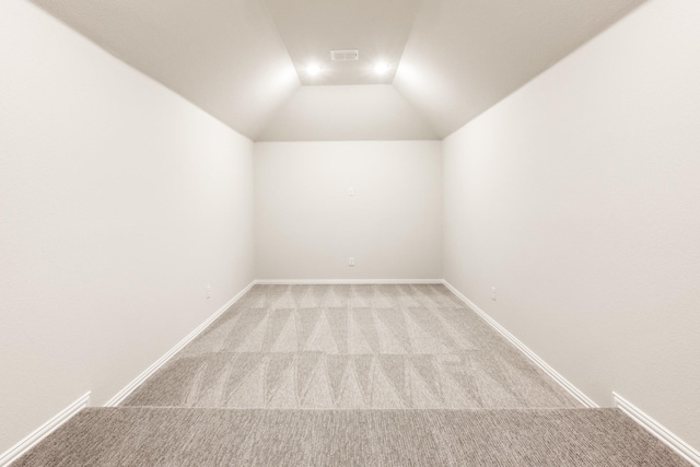 living room with ceiling fan, carpet floors, and vaulted ceiling