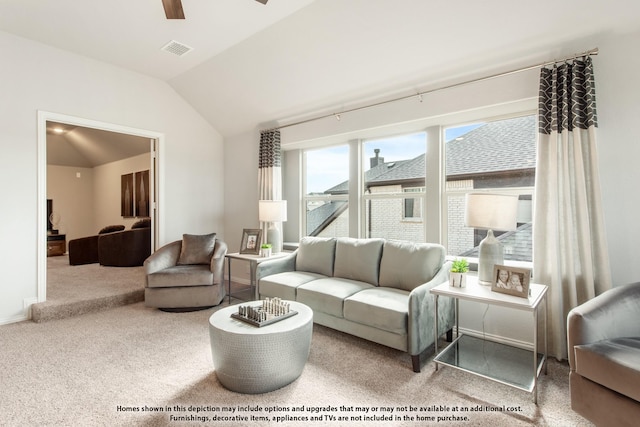 carpeted living room with ceiling fan and lofted ceiling