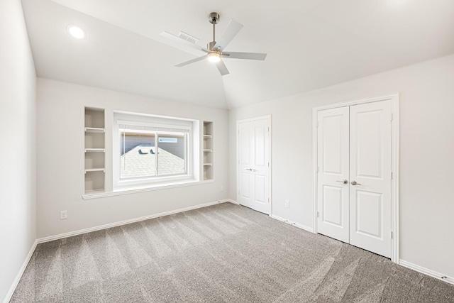 carpeted living room with vaulted ceiling