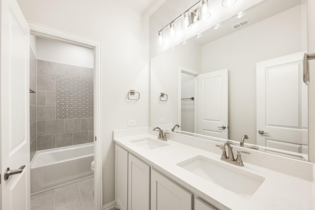 full bathroom with vanity, tiled shower / bath, and toilet