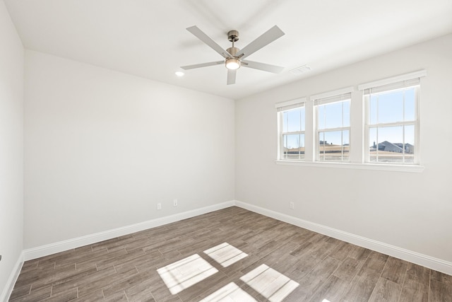 spare room featuring hardwood / wood-style floors and ceiling fan