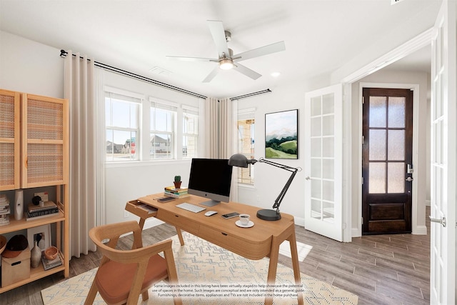 office area featuring ceiling fan, a healthy amount of sunlight, and light hardwood / wood-style floors