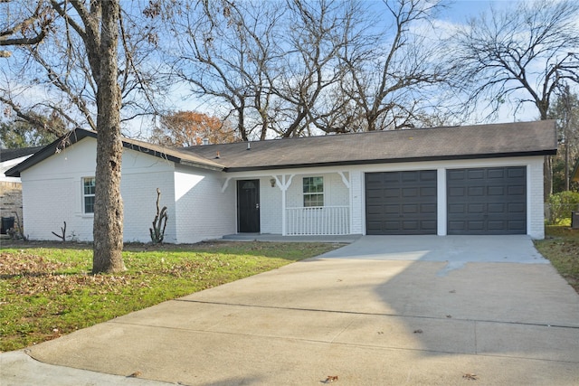 ranch-style house with a porch and a garage