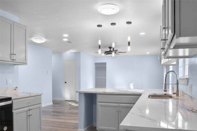 kitchen featuring gray cabinetry, ceiling fan, sink, and hanging light fixtures