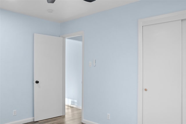 unfurnished bedroom featuring a closet, ceiling fan, and light hardwood / wood-style flooring