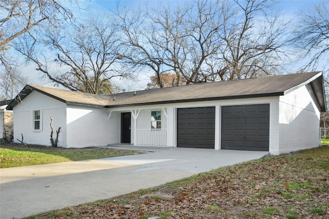 ranch-style house with covered porch and a garage