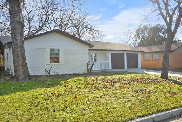 view of front facade with a front yard, a porch, and a garage