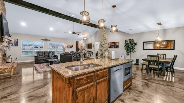 kitchen featuring appliances with stainless steel finishes, decorative light fixtures, sink, a kitchen island with sink, and ceiling fan