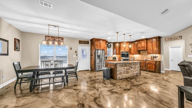 kitchen featuring decorative light fixtures, a kitchen bar, stainless steel appliances, and a kitchen island