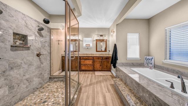 bathroom featuring hardwood / wood-style floors, vanity, and shower with separate bathtub