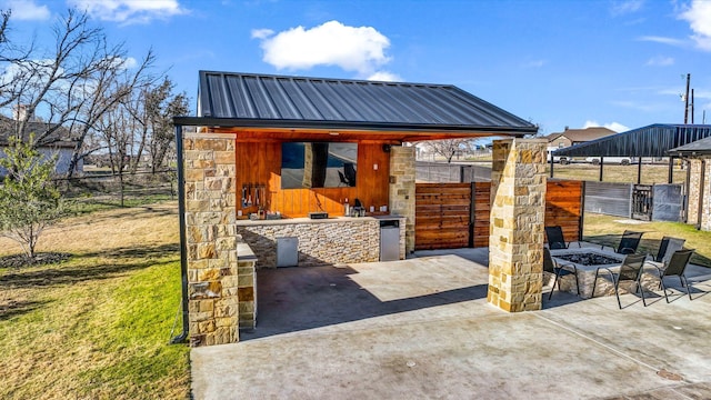 exterior space with an outdoor fire pit and area for grilling