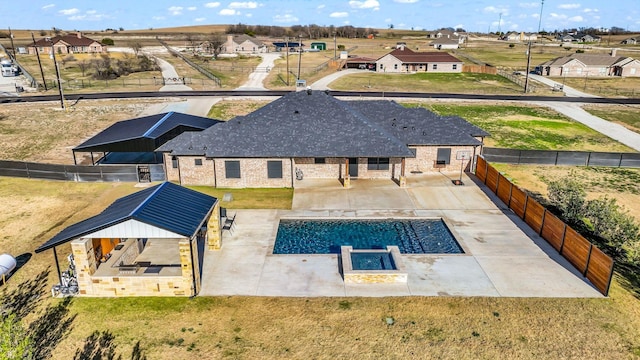 rear view of property featuring a patio area and a fenced in pool