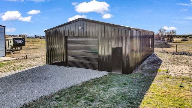 view of outdoor structure featuring a garage and a lawn