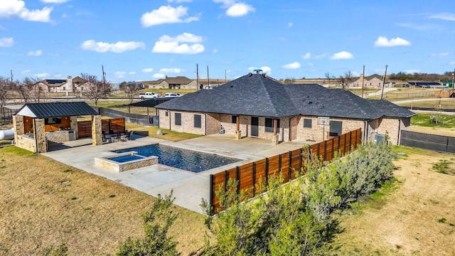 view of pool featuring an outdoor kitchen, a patio area, and an in ground hot tub