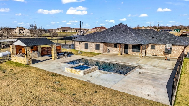 view of pool with an outdoor kitchen, a yard, exterior bar, an in ground hot tub, and a patio