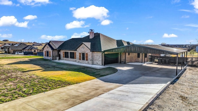 view of front facade featuring a front lawn, a garage, and a carport