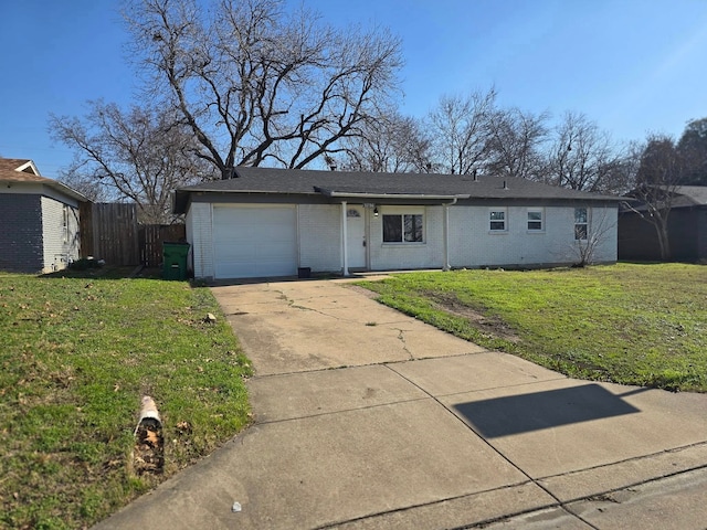 ranch-style home featuring a garage and a front lawn